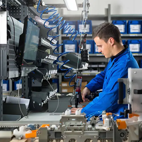 The picture illustrates a dedicated man working in the Commeo production hall.