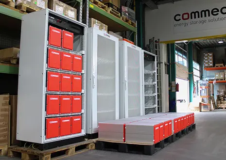 The image shown presents Commeo battery storage units in the middle of their production hall.